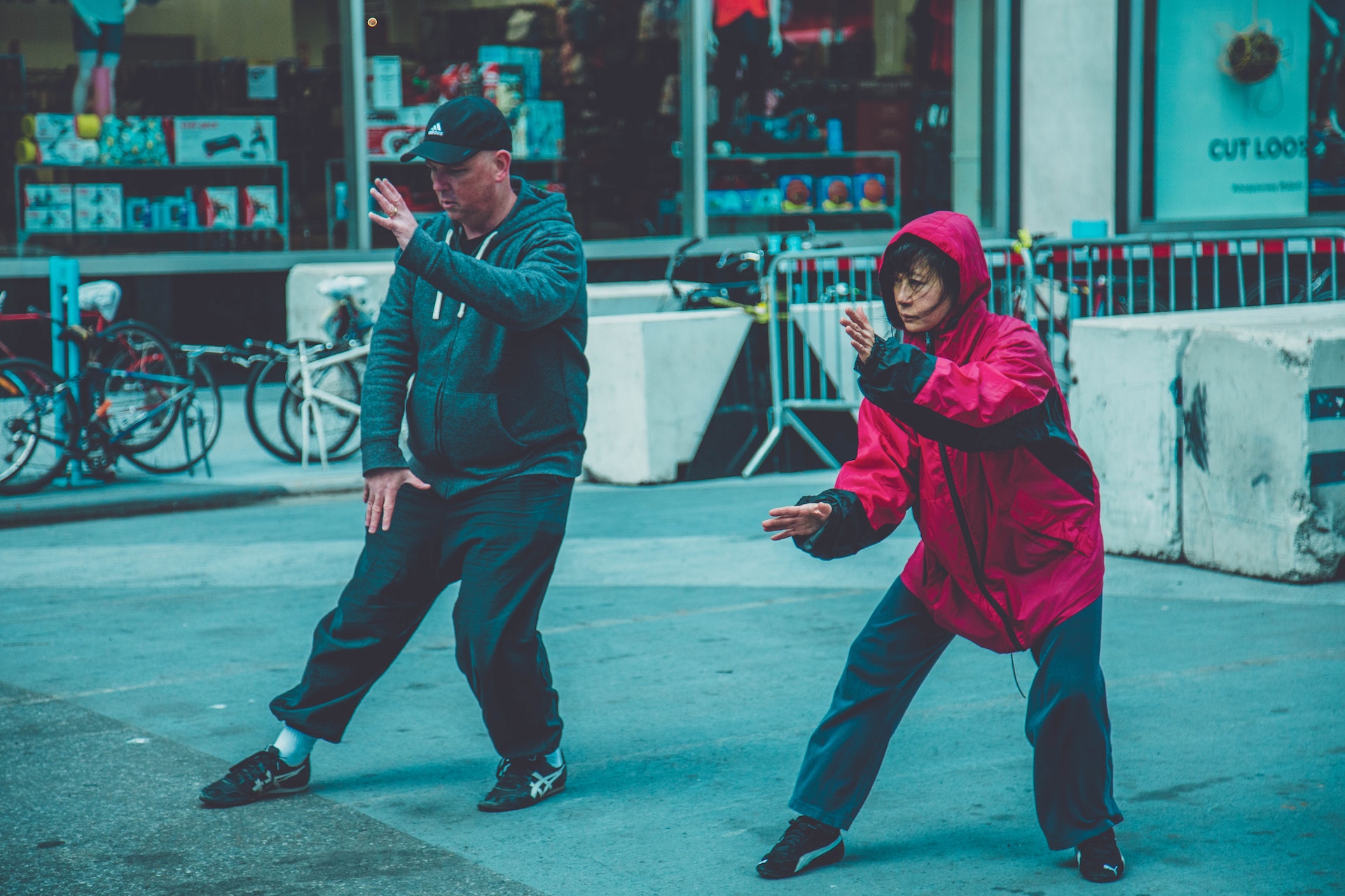 Two people performing Karate move in the streets